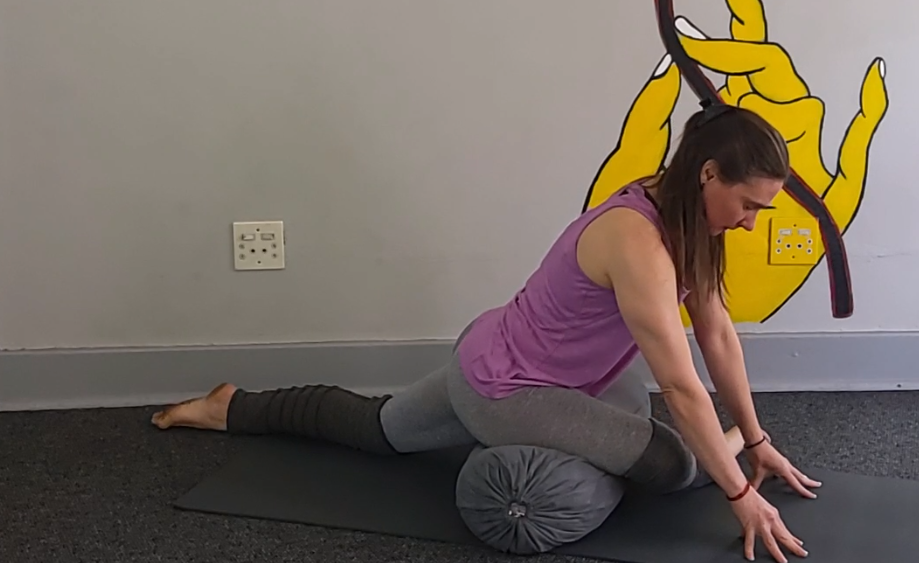 Pigeon stretch with bolster